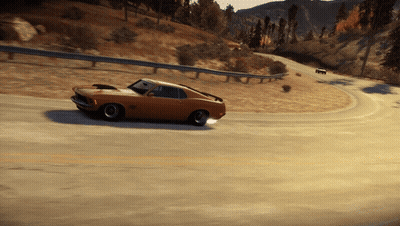 A Ford Mustang Is Driving Down A Road With Mountains In The Background GIF