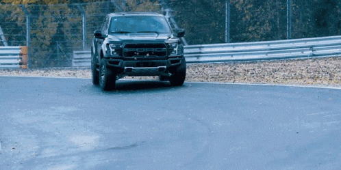 A Ford Raptor Is Driving Down A Curvy Road GIF