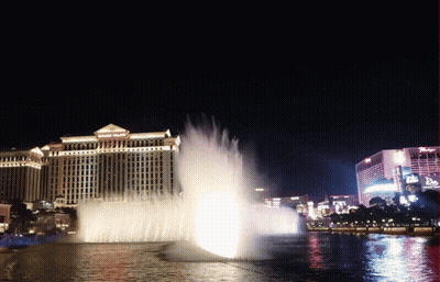 A Fountain In Front Of A Building That Says ' Bellagio ' On It GIF