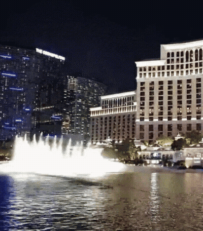 A Fountain In Front Of A Large Building That Says The Cosmopolitan GIF
