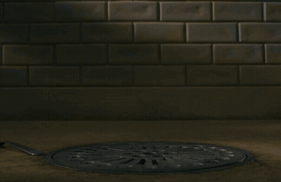 A Fox With A Fork And Knife Sticking Its Head Out Of A Manhole Cover GIF