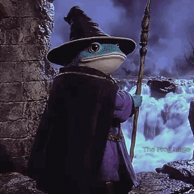 A Frog Dressed As A Wizard Is Holding A Wand GIF