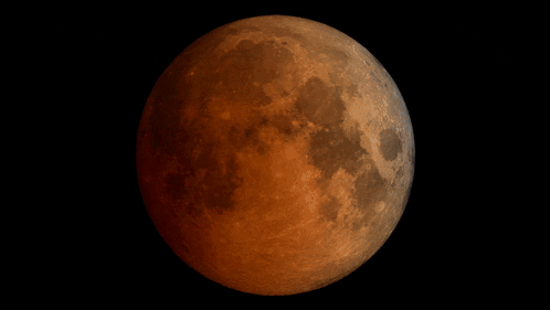A Full Moon Is Shown In A Black Background GIF