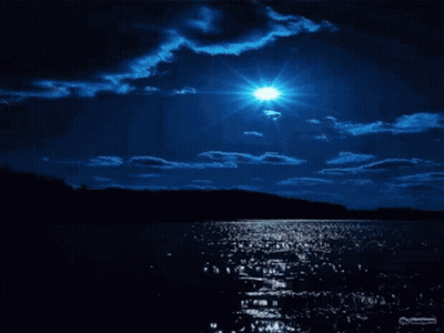 A Full Moon Shines Brightly Over A Lake At Night GIF