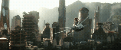 A Futuristic City With A Helicopter Flying Overhead GIF