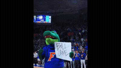 A Gator Mascot Is Holding A White Board That Says Ball Game GIF