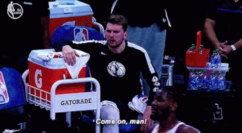 A Gatorade Cooler Sits Next To A Man In A Black Shirt GIF