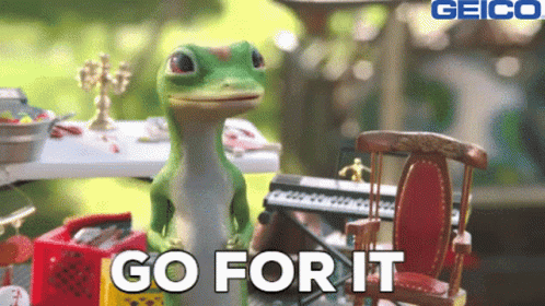 A Geico Ad Shows A Lizard Standing Next To A Keyboard GIF