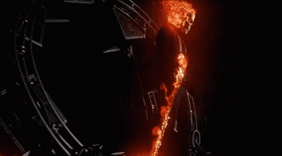 A Ghost Rider Is Flying Through The Air With A Flame Trail Behind Him GIF