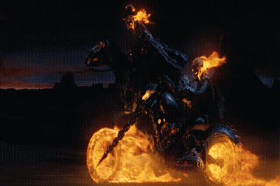 A Ghost Rider Is Riding A Motorcycle With Flames Coming Out Of The Wheels GIF