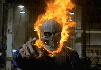 A Ghost Rider With Flames Coming Out Of His Head Is Pointing GIF