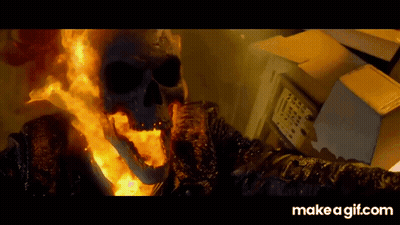 A Ghost Rider With Flames Coming Out Of His Mouth Is Standing Next To A Box GIF
