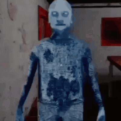 A Ghost With A White Face Is Standing In A Room In A Video Game . GIF