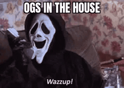 A Ghostface From The Movie Scream Is Sitting On A Couch Holding A Remote Control . GIF