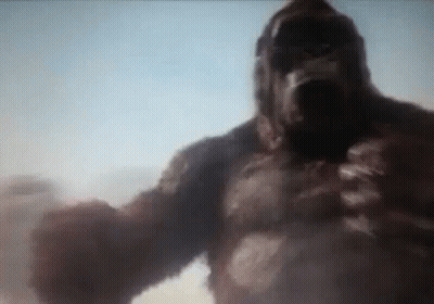 A Giant Gorilla Is Standing In The Middle Of The Desert . GIF