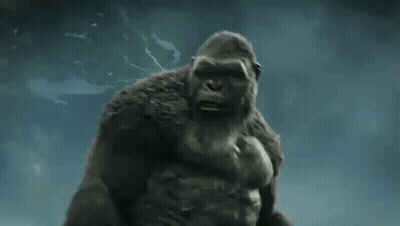 A Giant Gorilla Is Standing In The Water With His Arms Outstretched . GIF