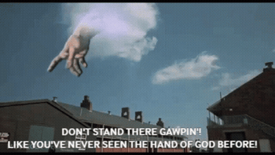 A Giant Hand Is Flying Through The Air With The Words " Don T Stand There Gawpin " GIF