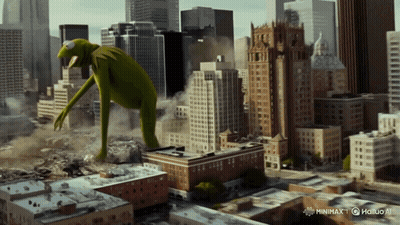 A Giant Kermit The Frog Is Standing In A City GIF