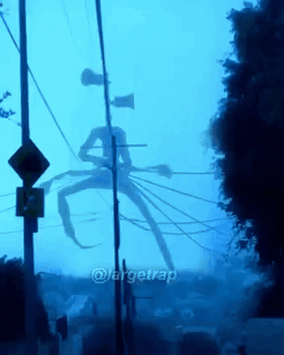 A Giant Monster With A Siren Head Is Standing In The Middle Of A Street GIF