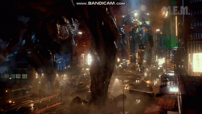 A Giant Robot Is Standing In The Middle Of A City At Night With The Words Www.bandicam.com In The Upper Right Corner GIF