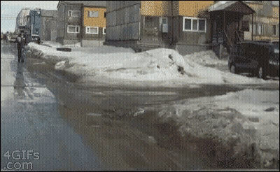 A Gif From 4Gifs.com Shows A Man Walking On A Snowy Street GIF
