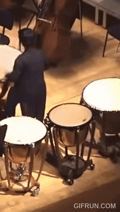 A Gif From Gifrun.com Shows A Man Playing A Drum Set GIF