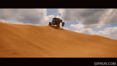 A Gif From Gifrun.com Shows A Vehicle Driving Down A Sandy Hill GIF