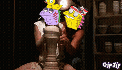 A Gif Of A Man And Woman Making A Pot With Cartoon Faces On Them GIF