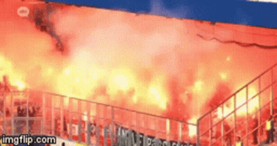 A Gif Of A Stadium With Flames Coming Out Of The Stands Is Being Displayed On Imgflip.com GIF