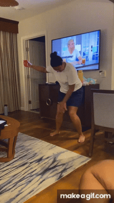 A Gif Of A Woman Dancing In Front Of A Tv With The Words Make A Gif.com At The Bottom GIF