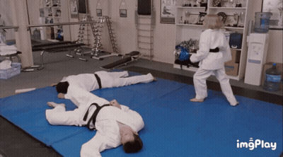 A Gif Of A Woman Kicking A Man On A Blue Mat With Imgplay Written On The Bottom GIF