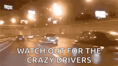 A Gif Of Cars Driving Down A Highway At Night With The Words Watch Out For The Crazy Drivers GIF