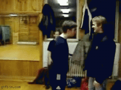 A Gifbin.com Image Of Two Men Standing Next To Each Other In A Room GIF