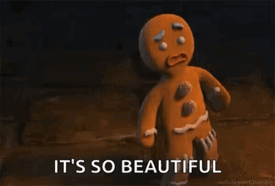 A Gingerbread Man From Shrek Is Standing In A Dark Room . GIF