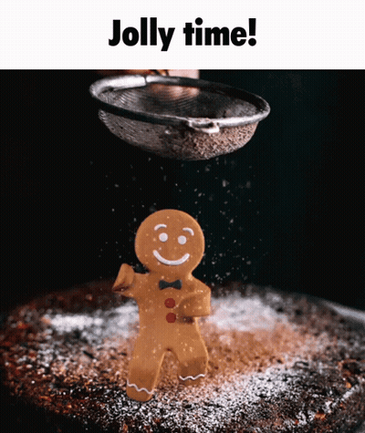 A Gingerbread Man Is Being Sprinkled With Powdered Sugar On A Cake GIF