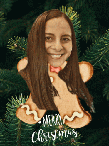 A Gingerbread Man Ornament With A Woman 'S Face On It And The Words Merry Christmas GIF