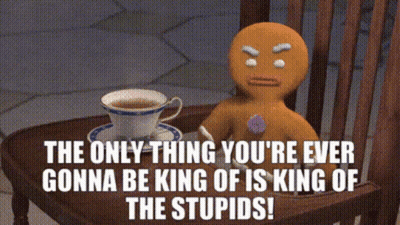 A Gingerbread Man Sits At A Table With A Cup Of Tea GIF