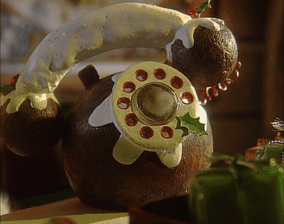 A Gingerbread Telephone With Icing On It GIF