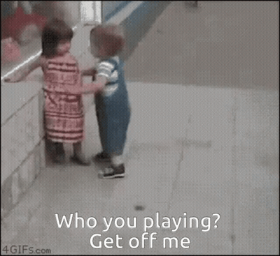 a girl and a boy are playing with a basketball and the girl asks the boy to get off her