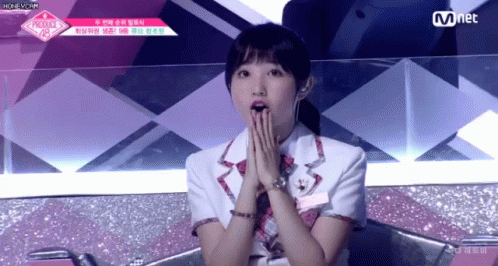 A Girl Covering Her Mouth With Her Hands While Sitting On A Chair . GIF