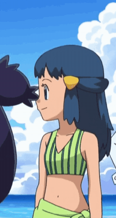 A Girl In A Bikini Is Standing On A Beach With Another Girl GIF