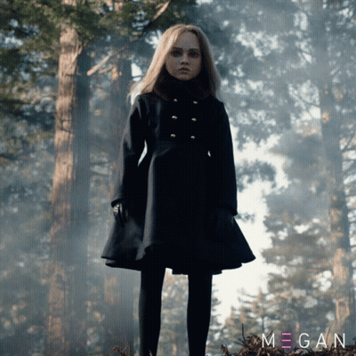 A Girl In A Black Coat Stands In A Forest With The Name Megan On The Bottom Left GIF