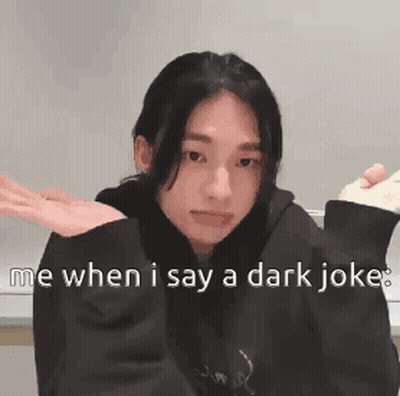 A Girl In A Black Hoodie Is Making A Funny Face While Holding A Remote Control . GIF