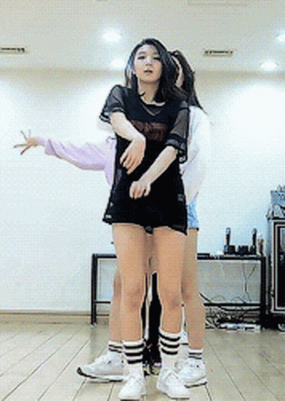 A Girl In A Black Shirt That Says ' Nct ' On It Is Hugging Another Girl GIF