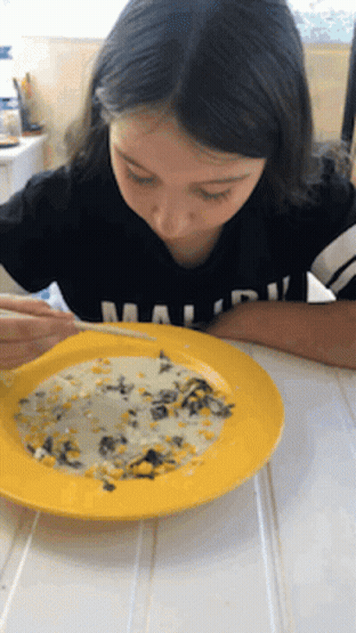 A Girl In A Black Shirt With The Word Malibu On It GIF