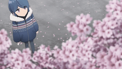 A Girl In A Blue And White Striped Jacket Stands In Front Of A Tree With Pink Flowers GIF