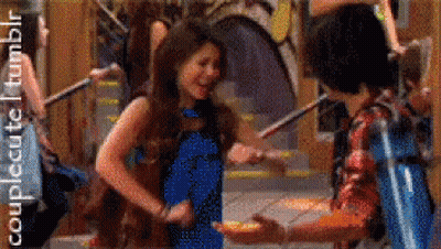 A Girl In A Blue Dress Is Dancing With A Boy In A Red Plaid Shirt GIF