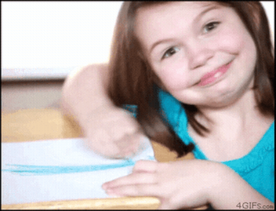 A Girl In A Blue Shirt Is Smiling And Making A Funny Face GIF
