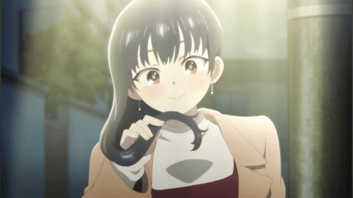 A Girl In A Brown Coat Is Holding Her Hair GIF