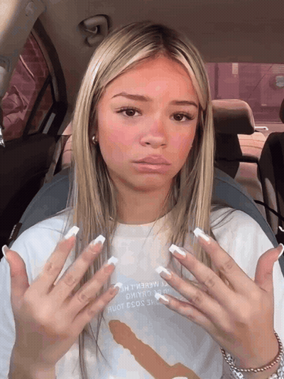 A Girl In A Car With A T-Shirt That Says " I Love You " GIF